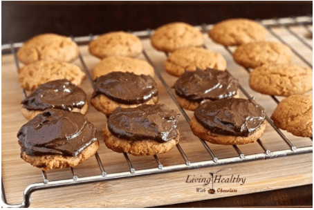 almond cookies topped with chocolate avocado fudge frosting