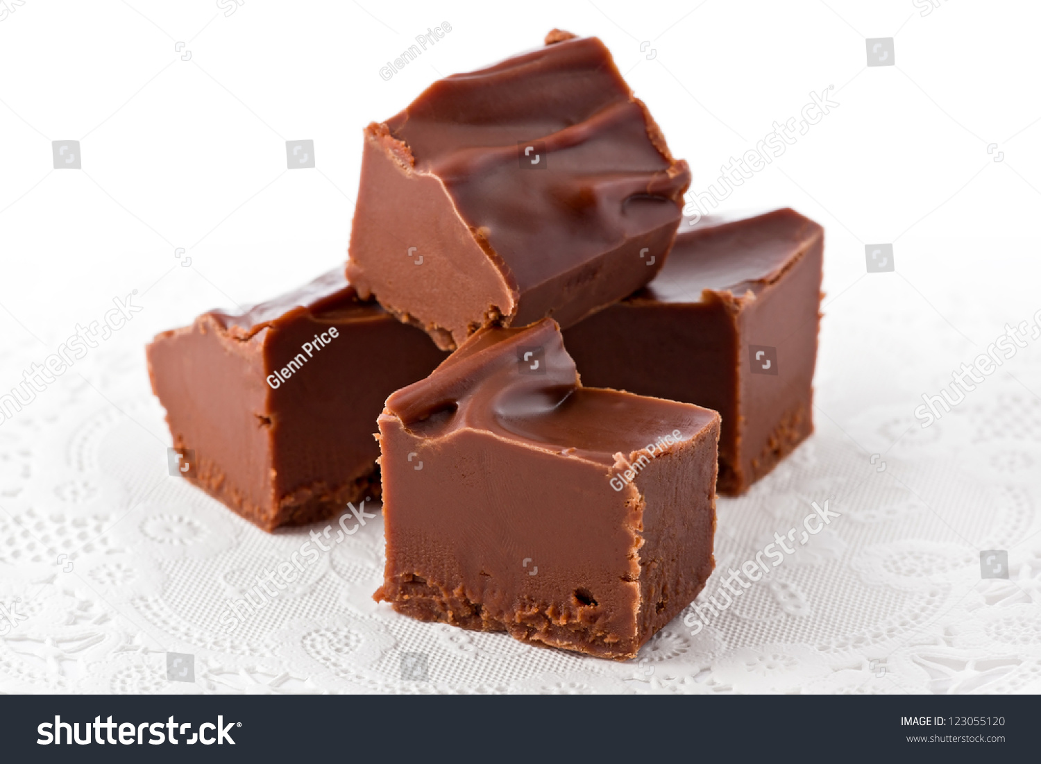 stock photo four pieces of chocolate fudge on a white doily 123055120